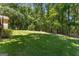 Large, private backyard surrounded by lush trees at 423 Holly Grove Church Rd, Peachtree City, GA 30269