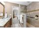 Bright bathroom featuring a marble counter top, tile floors and a glass enclosed shower at 423 Holly Grove Church Rd, Peachtree City, GA 30269