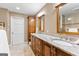 Spacious bathroom featuring a granite countertop, wood cabinets, and double sinks at 423 Holly Grove Church Rd, Peachtree City, GA 30269