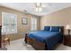 Bedroom with ceiling fan, windows, and a bed with blue comforter at 423 Holly Grove Church Rd, Peachtree City, GA 30269