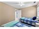 Bedroom featuring two beds with blue accents, large window and a ceiling fan at 423 Holly Grove Church Rd, Peachtree City, GA 30269