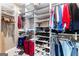 Walk-in closet with shelving, hanging rods, shoes, and a suitcase for optimal storage at 423 Holly Grove Church Rd, Peachtree City, GA 30269