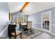 Vaulted dining room features a chandelier, backyard views, stylish furniture, and hardwood floors at 423 Holly Grove Church Rd, Peachtree City, GA 30269