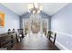 Beautiful dining room features a vaulted ceiling, backyard views, stylish furniture, and hardwood floors at 423 Holly Grove Church Rd, Peachtree City, GA 30269
