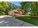 Brick home with a long driveway, garage, well-maintained lawn, and flagpole showing American pride at 423 Holly Grove Church Rd, Peachtree City, GA 30269