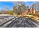 A charming two-story red brick home with a classic design, set on a large lot with mature trees at 423 Holly Grove Church Rd, Peachtree City, GA 30269