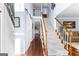 Spacious foyer featuring hardwood floors, a staircase, and an upper-level view, bathed in natural light at 423 Holly Grove Church Rd, Peachtree City, GA 30269