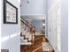 Inviting foyer with hardwood floors, a staircase, and a glimpse into the living area at 423 Holly Grove Church Rd, Peachtree City, GA 30269
