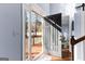 Open front door revealing a bright foyer with hardwood floors and a staircase leading to the upper level at 423 Holly Grove Church Rd, Peachtree City, GA 30269