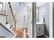 Entryway showcasing hardwood floors, a white front door, and convenient half-bath access at 423 Holly Grove Church Rd, Peachtree City, GA 30269