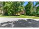Lovely brick home nestled among trees, boasting a green lawn and inviting landscaping, providing a serene setting at 423 Holly Grove Church Rd, Peachtree City, GA 30269