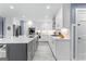 Bright eat-in kitchen features white cabinets, stainless steel appliances, stone countertops, and a grey island at 423 Holly Grove Church Rd, Peachtree City, GA 30269