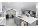 Large eat-in kitchen features stone countertops, grey island, stainless steel appliances, and view to the backyard at 423 Holly Grove Church Rd, Peachtree City, GA 30269