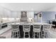 This eat-in kitchen has white cabinets, stainless steel appliances, stone countertops, an island, and pendant lights at 423 Holly Grove Church Rd, Peachtree City, GA 30269