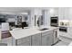 Spacious eat-in kitchen features stone countertops, grey island, stainless steel appliances, and a view into the living room at 423 Holly Grove Church Rd, Peachtree City, GA 30269