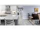 Bright eat-in kitchen features white cabinets, stone countertops, a grey island, and views to the dining room at 423 Holly Grove Church Rd, Peachtree City, GA 30269