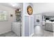 Bright laundry room features shelving, window, gray tile floor, and modern appliances at 423 Holly Grove Church Rd, Peachtree City, GA 30269