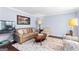 Cozy living room featuring a comfortable sofa, a patterned rug, and a decorative coffee table, perfect for relaxation at 423 Holly Grove Church Rd, Peachtree City, GA 30269