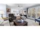 Bright living room features a ceiling fan, hardwood floors, plush area rug, and an abundance of natural light at 423 Holly Grove Church Rd, Peachtree City, GA 30269