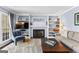 Comfortable living area with a fireplace, built-in shelving, and a plush carpet at 423 Holly Grove Church Rd, Peachtree City, GA 30269