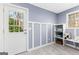 Mudroom with door to the backyard and storage bench provides a practical and stylish transition space at 423 Holly Grove Church Rd, Peachtree City, GA 30269