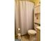Simple bathroom with shower, toilet, and storage cabinet for essential items at 924 Polk Rd, Moreland, GA 30259