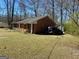 Image shows the front of the brick home, offering a glimpse of the property's exterior at 924 Polk Rd, Moreland, GA 30259