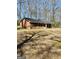 Distant view of the brick home with a spacious lawn at 924 Polk Rd, Moreland, GA 30259
