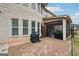 Brick patio with a grill, leading to a screened-in porch and a spacious, partially fenced backyard at 3225 Alhambra Cir, Hampton, GA 30228