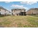 View of the backyard featuring a screened-in porch and well-maintained lawn at 3225 Alhambra Cir, Hampton, GA 30228