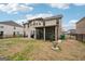 Spacious backyard with a screened in porch and manicured landscaping at 3225 Alhambra Cir, Hampton, GA 30228