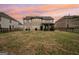 Spacious backyard features a covered patio and full fence, perfect for outdoor gatherings at 3225 Alhambra Cir, Hampton, GA 30228