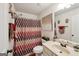 Bathroom with patterned shower curtain and vanity at 3225 Alhambra Cir, Hampton, GA 30228