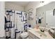 Stylish bathroom with shower-tub, vanity, and decorative blue and gray patterned shower curtain at 3225 Alhambra Cir, Hampton, GA 30228