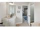 Bright bathroom with white cabinets, neutral tile floor and an open doorway to an adjacent room at 3225 Alhambra Cir, Hampton, GA 30228