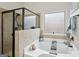 Close up of tub in bathroom with enclosed glass shower at 3225 Alhambra Cir, Hampton, GA 30228