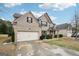 Lovely two-story brick home with attached garage, manicured landscaping, and covered front porch at 3225 Alhambra Cir, Hampton, GA 30228