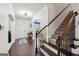 Welcoming foyer with hardwood floors, staircase and natural light streaming in at 3225 Alhambra Cir, Hampton, GA 30228