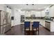 Well appointed kitchen with stainless steel appliances, island with seating, and granite countertops at 3225 Alhambra Cir, Hampton, GA 30228