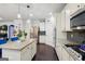 Open kitchen features granite counters, stainless steel appliances and a functional center island at 3225 Alhambra Cir, Hampton, GA 30228