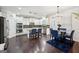 Bright kitchen features granite countertops, stainless steel appliances, and dark hardwood floors at 3225 Alhambra Cir, Hampton, GA 30228