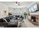 Inviting living room with fireplace, TV, tile floors, and stylish, comfortable sectional sofa at 3225 Alhambra Cir, Hampton, GA 30228