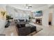 Bright living room with a fireplace, TV, tile floors, and large sectional sofa at 3225 Alhambra Cir, Hampton, GA 30228