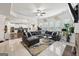 Spacious living room with fireplace, TV, tile floors, sectional sofa and open to the kitchen at 3225 Alhambra Cir, Hampton, GA 30228