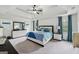 Spacious primary bedroom boasts tray ceiling, fan, and matching furniture at 3225 Alhambra Cir, Hampton, GA 30228