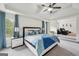 Bright main bedroom with tray ceiling, ceiling fan, en-suite seating area and two windows at 3225 Alhambra Cir, Hampton, GA 30228