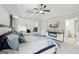 Spacious main bedroom with tray ceilings, ceiling fan, and a TV over the fireplace at 3225 Alhambra Cir, Hampton, GA 30228