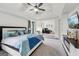 Comfortable primary bedroom with en-suite seating area and tv at 3225 Alhambra Cir, Hampton, GA 30228