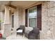 Inviting front porch features comfortable seating and a view of the beautifully landscaped front yard at 3225 Alhambra Cir, Hampton, GA 30228