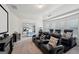 A spacious home theater room with seating and view into the main bedroom at 3225 Alhambra Cir, Hampton, GA 30228